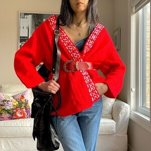 Bright red knit open front cardigan with white knit pattern